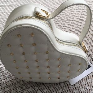 White heart shape mini bag with gold chain.